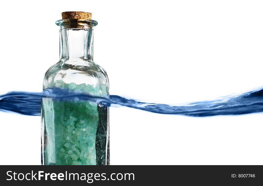 Bottle of bath salts sitting in a blue wave of water. Bottle of bath salts sitting in a blue wave of water.