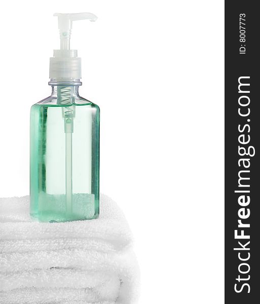 A spa scene on top of fluffy white towels against a white background.