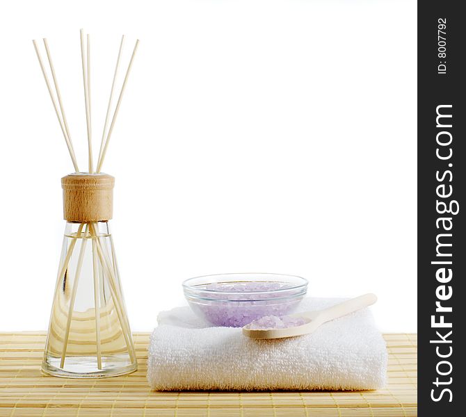 Spa scene on top of a bamboo mat and against a white background.