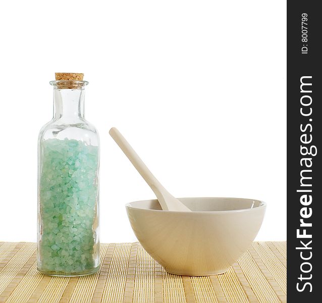 Bottle of salt and bowl of treatment against a white background. Bottle of salt and bowl of treatment against a white background.