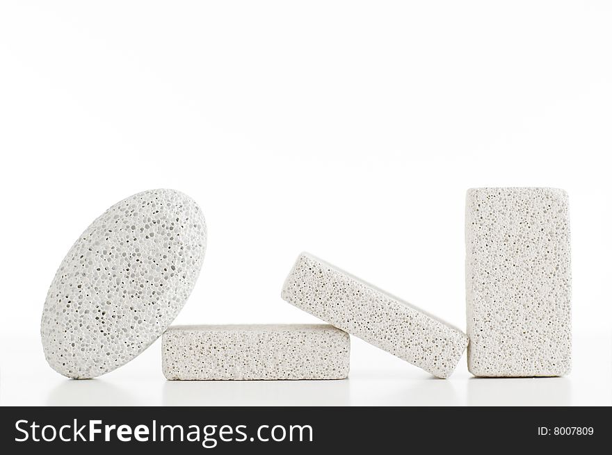 Pumice stones against a white background, sleight reflection. Pumice stones against a white background, sleight reflection.
