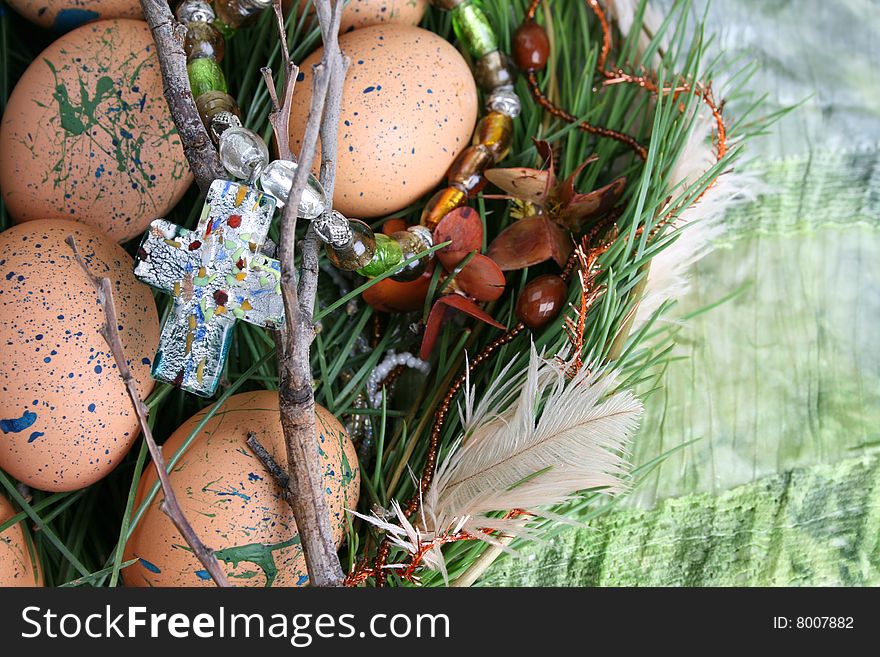 Decorated eggs in a wreath on a green background. Decorated eggs in a wreath on a green background