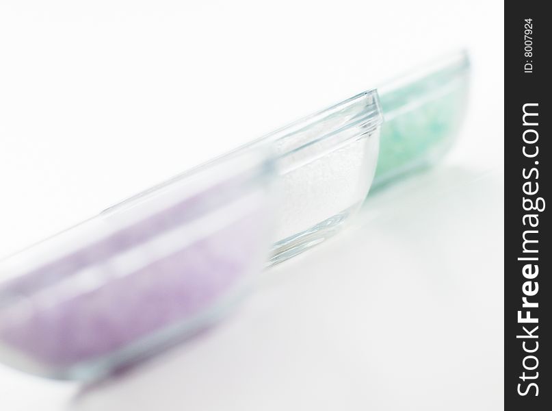 Bowls of colorful bath salt against a white background. Bowls of colorful bath salt against a white background.