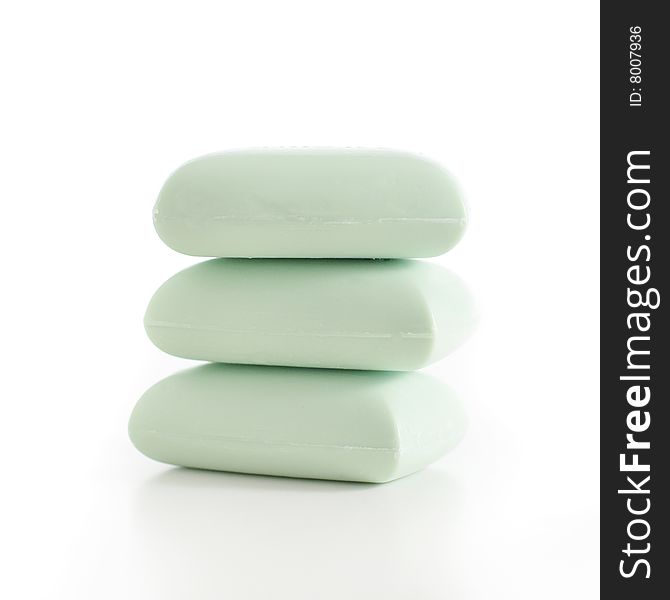 Stack of green soap bars against a white background. Stack of green soap bars against a white background.