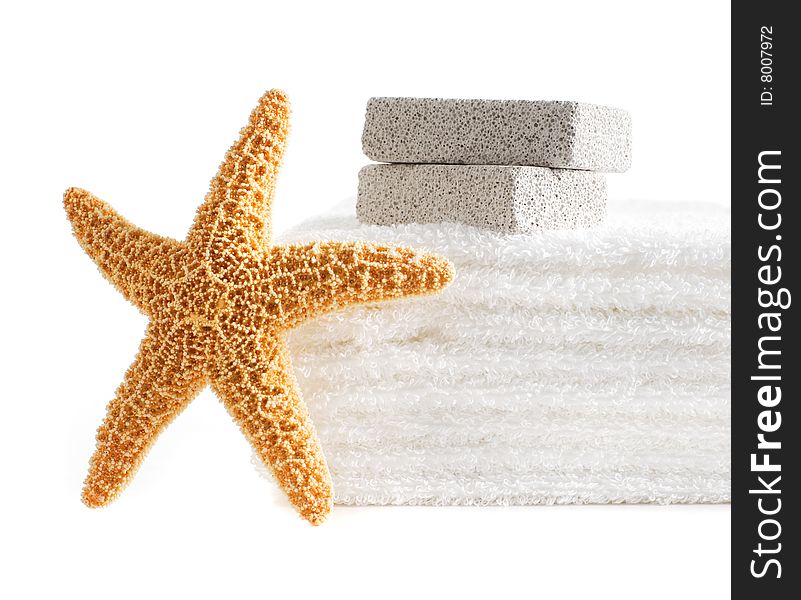 Starfish, towels, and pumice stones against a white background. Starfish, towels, and pumice stones against a white background.