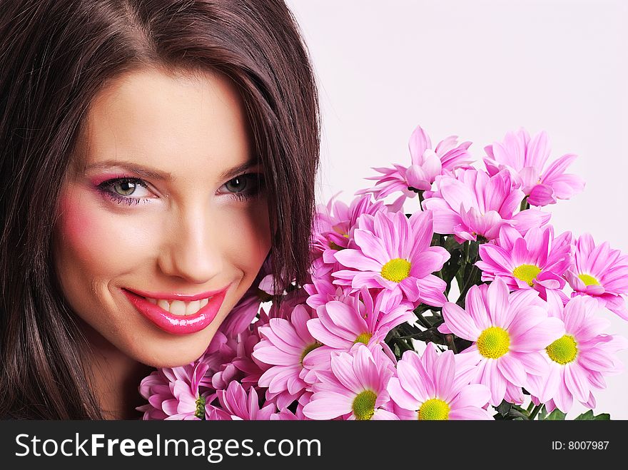 Attractive young woman face with flowers. Attractive young woman face with flowers