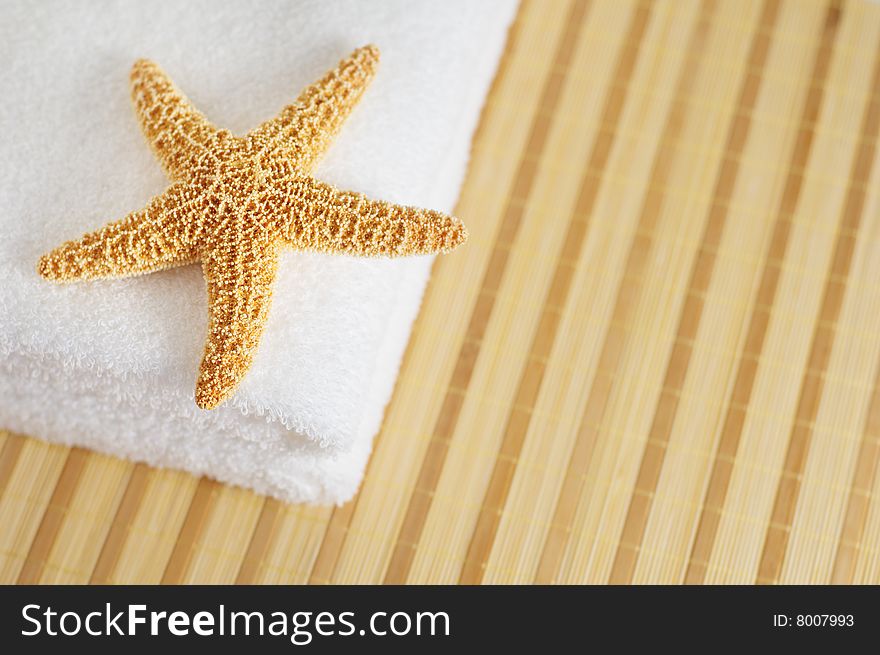 Starfish and towels on a bamboo mat. Starfish and towels on a bamboo mat.