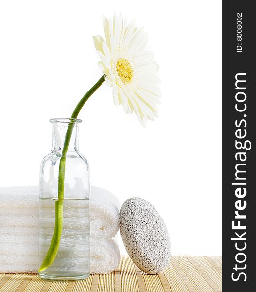 Flower, towels, and pumice stone against a white background. Flower, towels, and pumice stone against a white background.