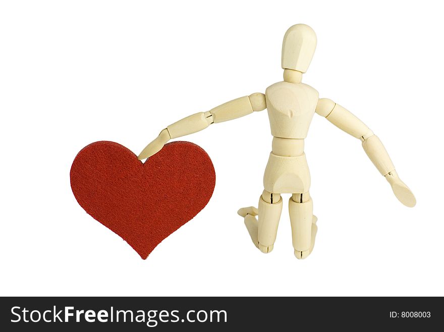 A wooden dummy figurine kneeling down and offering his love - a big red heart in an engagement proposal gesture. A wooden dummy figurine kneeling down and offering his love - a big red heart in an engagement proposal gesture.