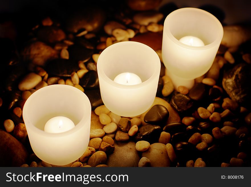 Candels buring at night on top of rocks. Candels buring at night on top of rocks.