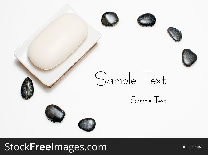 Soap dish and black rocks against a white background. Soap dish and black rocks against a white background.