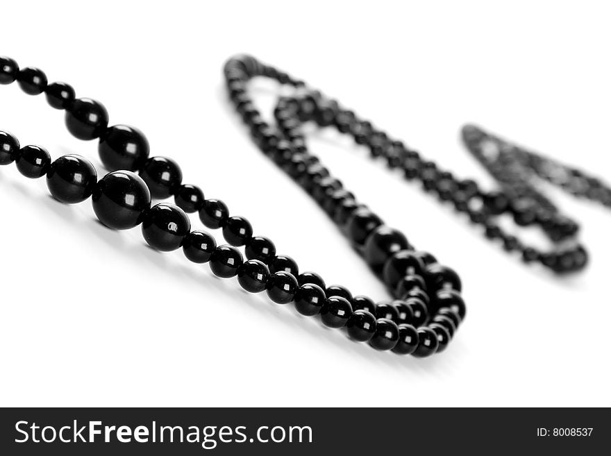Black necklace on a white background
