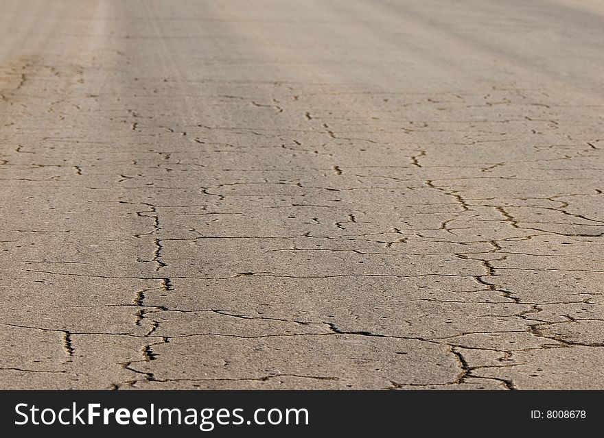 View of cracked asphalt road.