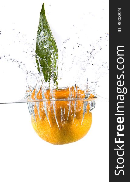 Tangerine in water with bubbles on white ground
