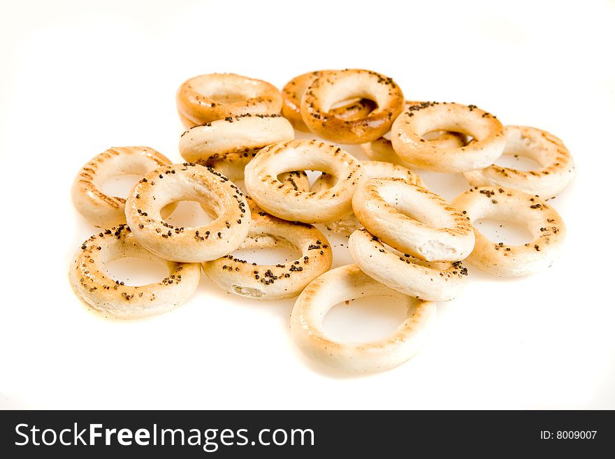 Heap of bread-rings on white ground