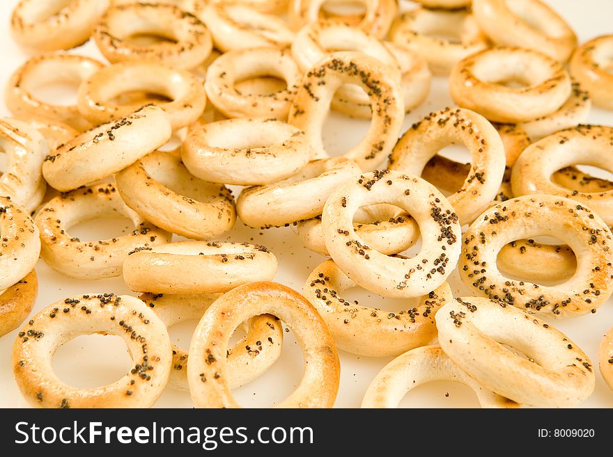 Bread-rings with poppyseed as a background