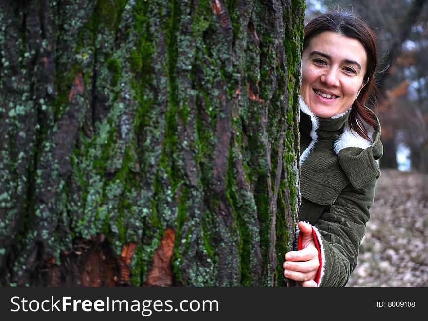 Girl stands behind a tree - nice portrait. Girl stands behind a tree - nice portrait