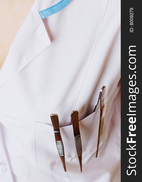 Nurse gown pocket with tweezers