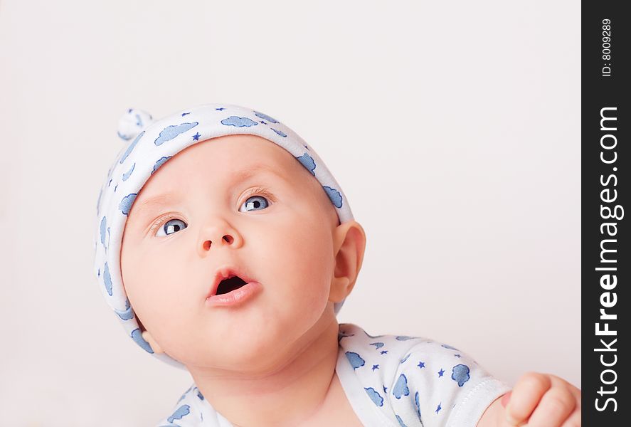 Small cute surprised child in blue pajama