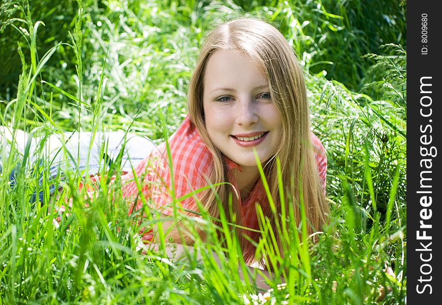 Portrait of beautiful woman lying at grass. Portrait of beautiful woman lying at grass