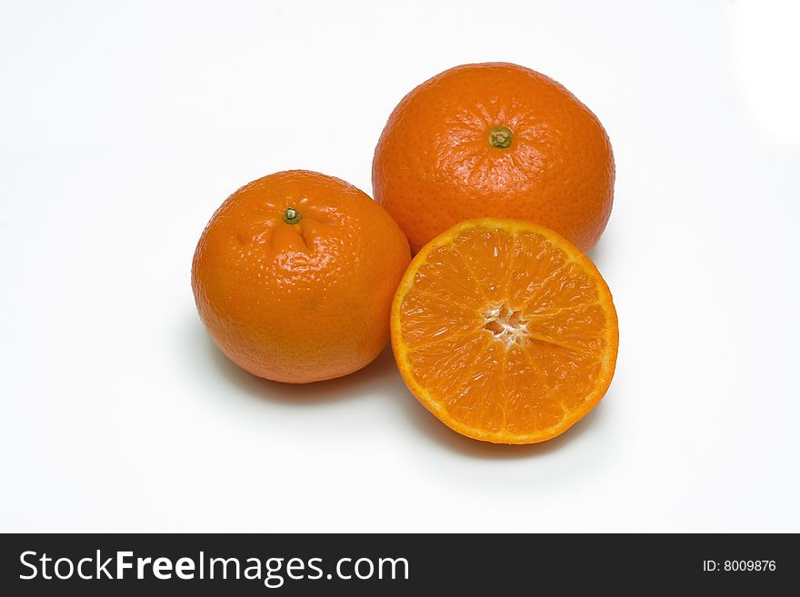 Three juicy mandarins on white background.