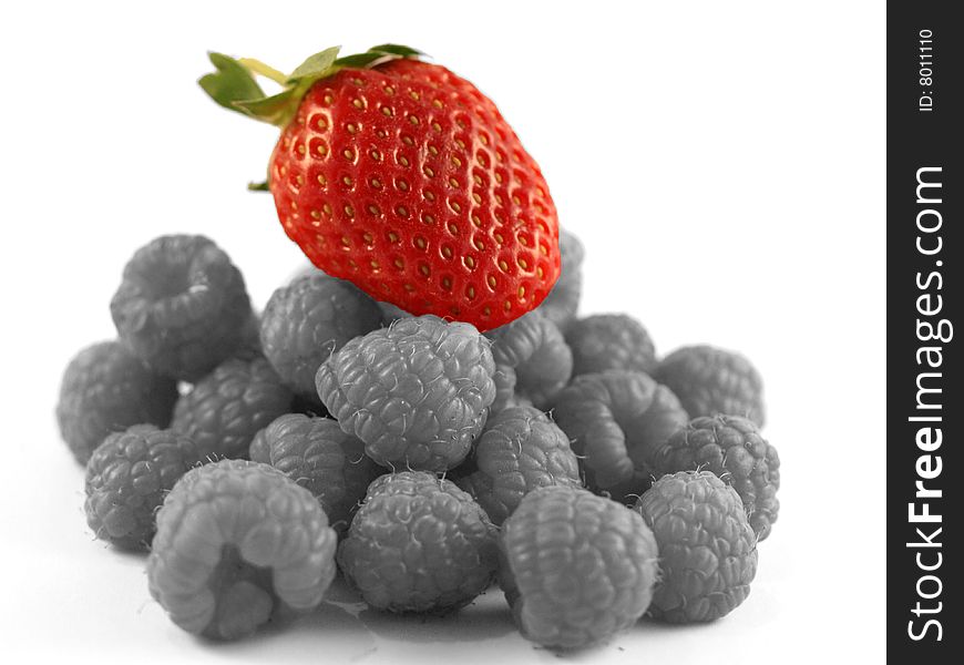 Red Strawberry on a bed of Black and White Raspberries. Red Strawberry on a bed of Black and White Raspberries