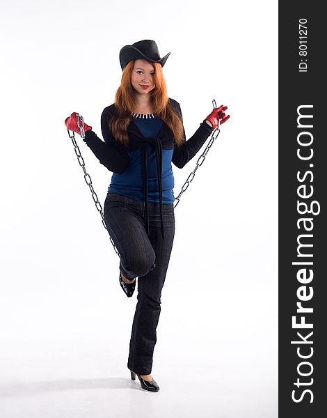 Young girl with red gloves, chain and black hat standing on white background. Young girl with red gloves, chain and black hat standing on white background