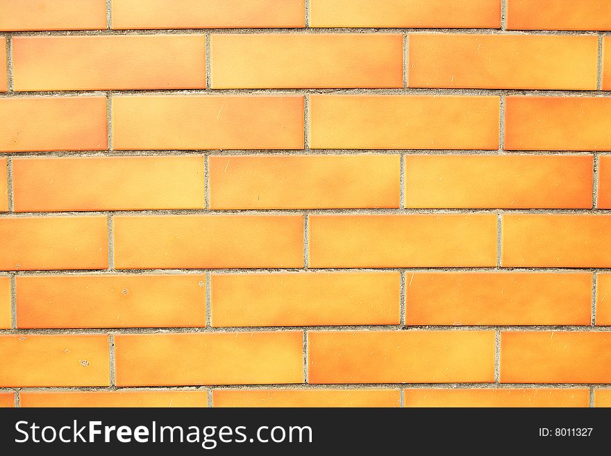 Orange grunge brick wall background.