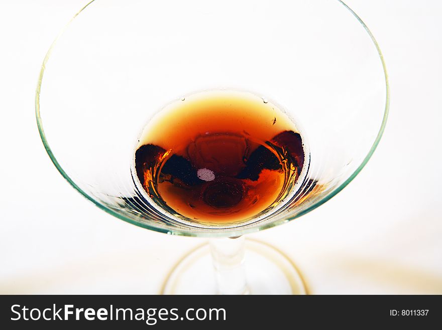 Wine being poured into a wine glass on white background