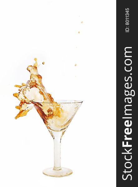 Wine being poured into a wine glass on white background