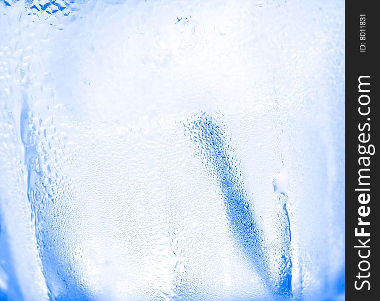 Water drops on glass with ice for background