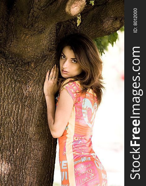 Attractive girl near the tree