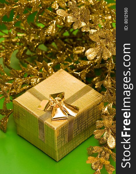 Golden gift box with decoration leaves