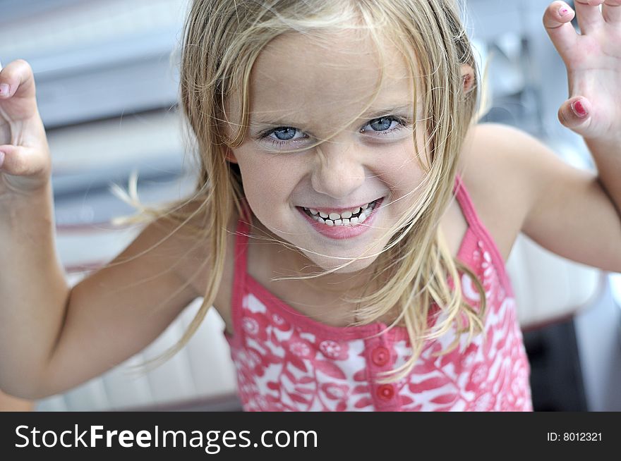 A cute little girl makes faces. A cute little girl makes faces