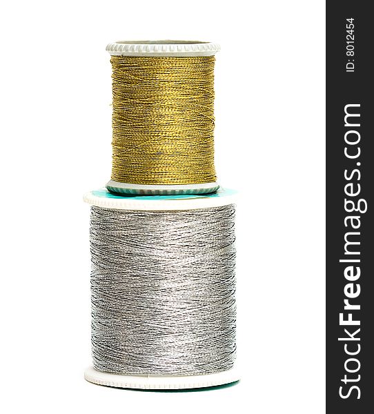 Golden and silver spools of threads