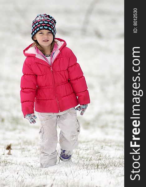 A cute little girl walking in the snow. A cute little girl walking in the snow