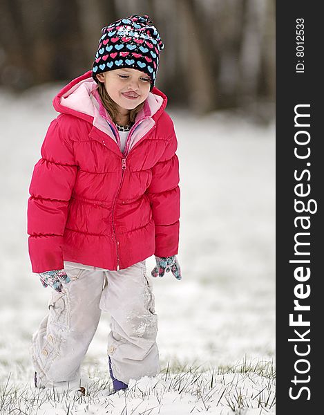 A cute little girl walking in the snow. A cute little girl walking in the snow