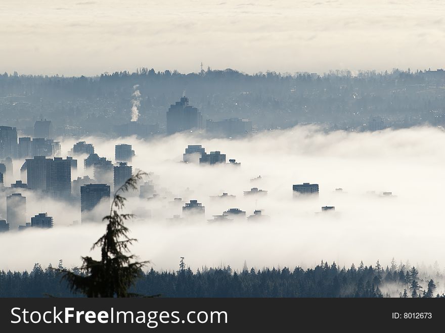 Buildings above the clouds. This view is from a mountain looking west. Buildings above the clouds. This view is from a mountain looking west.