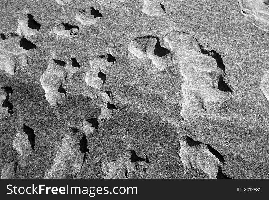 A close-up image of sand. Black and white texture. A close-up image of sand. Black and white texture.