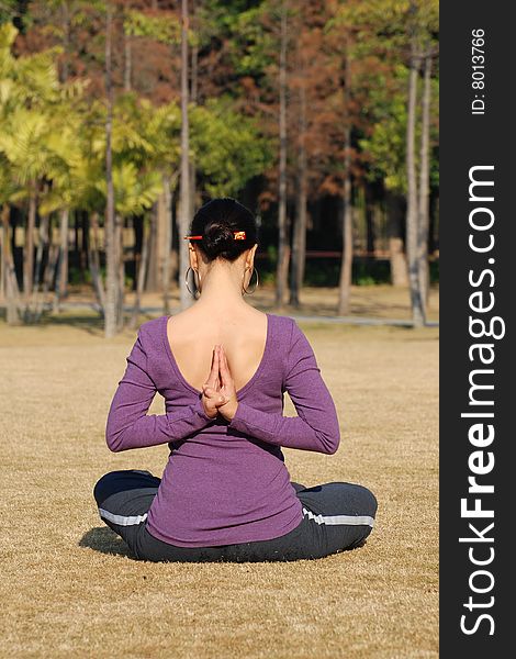 Young Asian Woman exercising Yoga in the park. Young Asian Woman exercising Yoga in the park