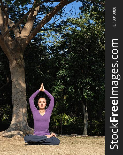 Young Asian Woman exercising Yoga in park