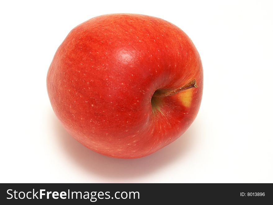 One red apple laying on it's side.