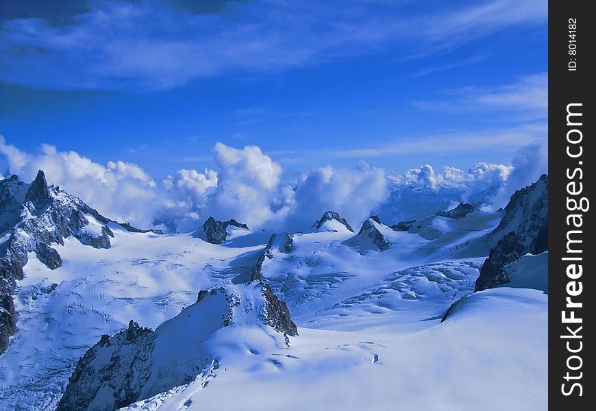 An overview of a beautiful mountain landscape covered by snow. An overview of a beautiful mountain landscape covered by snow