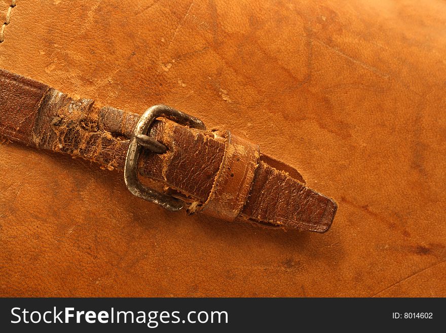 Ginger leather background with ancient buckle and belt