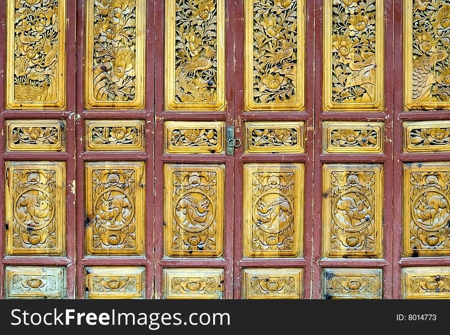 Wooden door in old style, shop entrance. China, Yunnan province, Lijiang - old town.