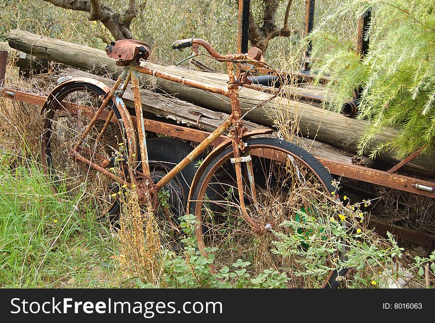 Old rusty bicycle, forgotten near the house in the Italian mountains. Old rusty bicycle, forgotten near the house in the Italian mountains
