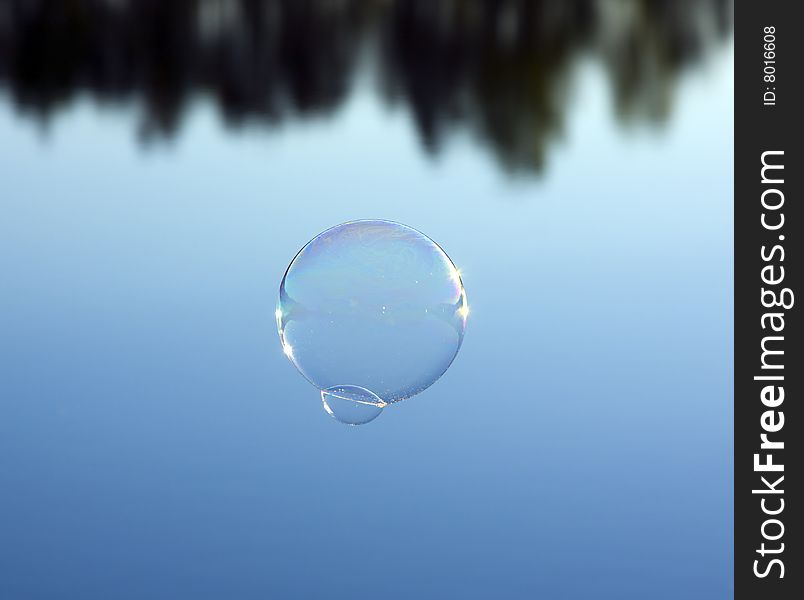 Bubble flies on blue water background. Bubble flies on blue water background