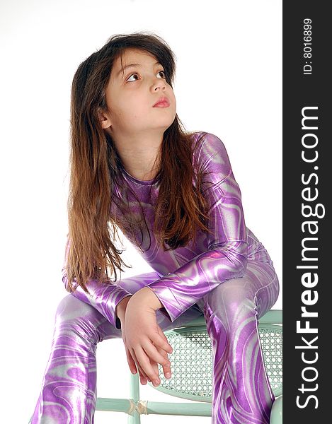 Girl dressed a bright disco suit sitting thoughtful. Girl dressed a bright disco suit sitting thoughtful