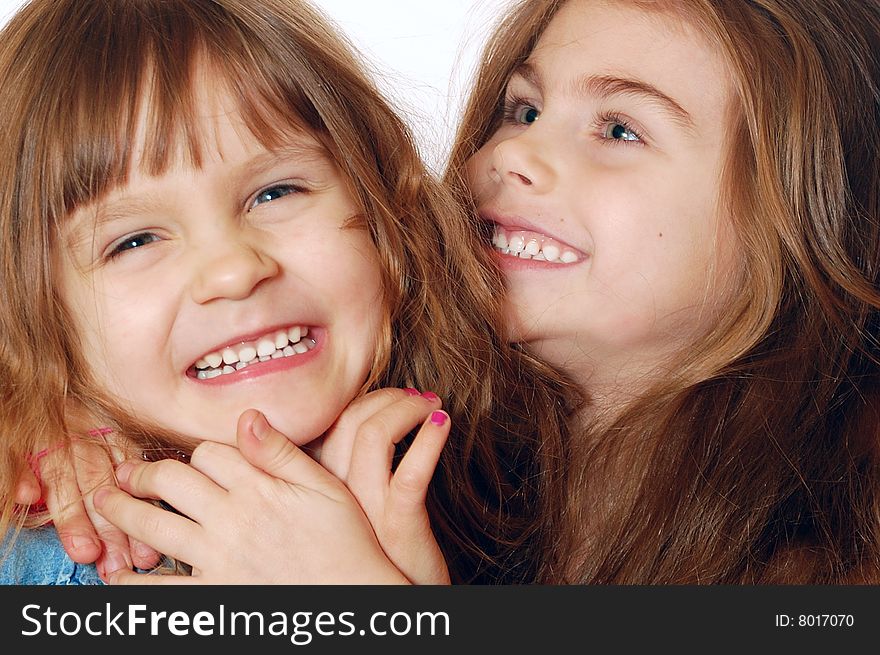 Two little 4 year old laughing playful girls. Close-up. Two little 4 year old laughing playful girls. Close-up.