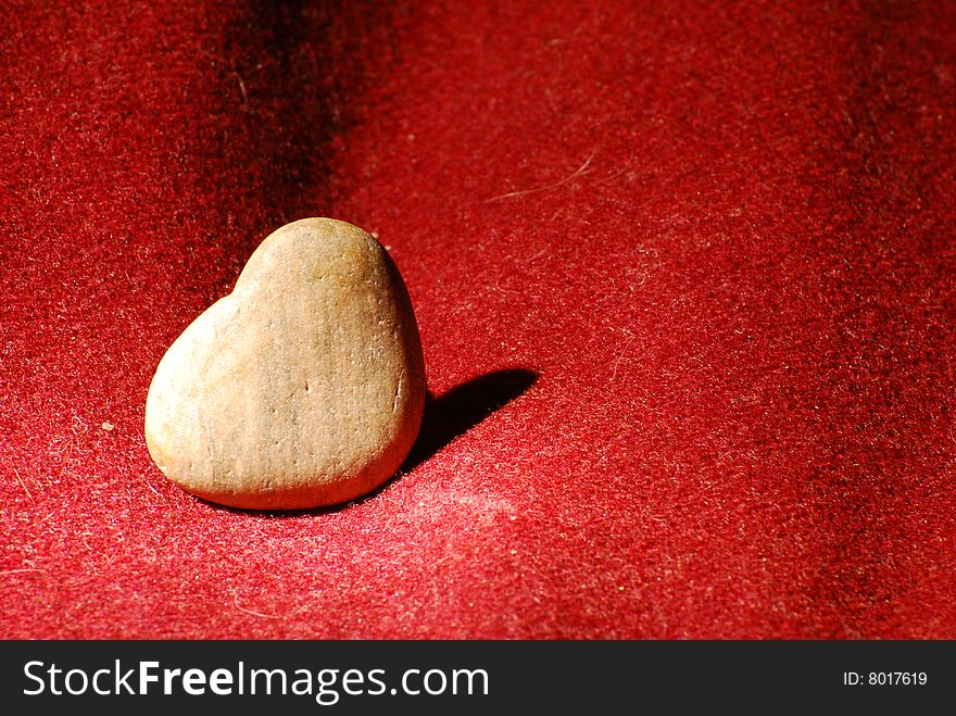 Heart made of stone in purple background